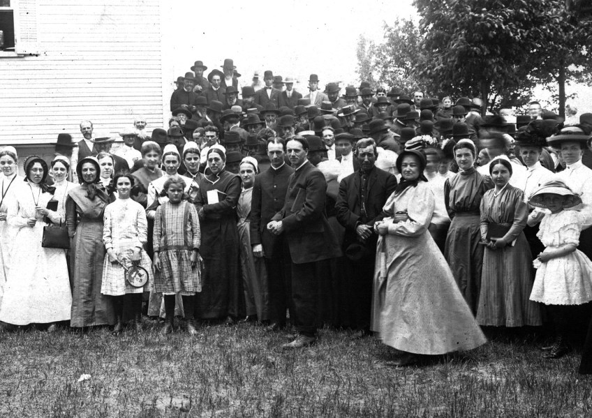 A group of men and women stand outside a church building during the 1911 General Conference of the Brethren in Christ Church