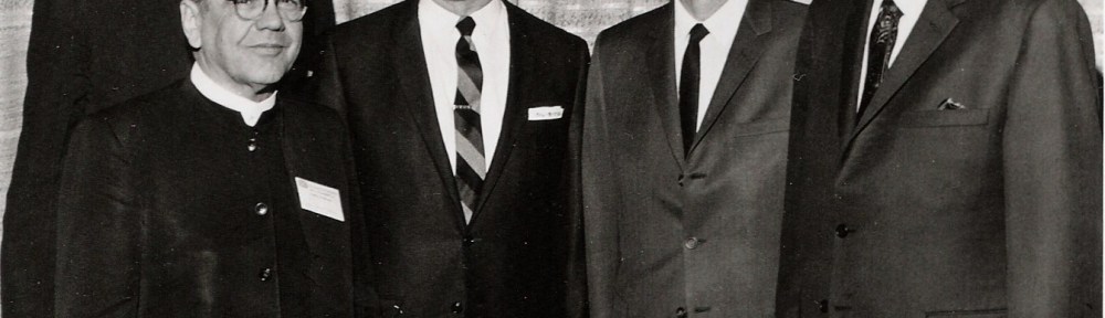 Five white men pose for a photograph