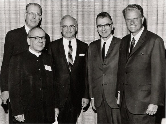 Five white men pose for a photograph